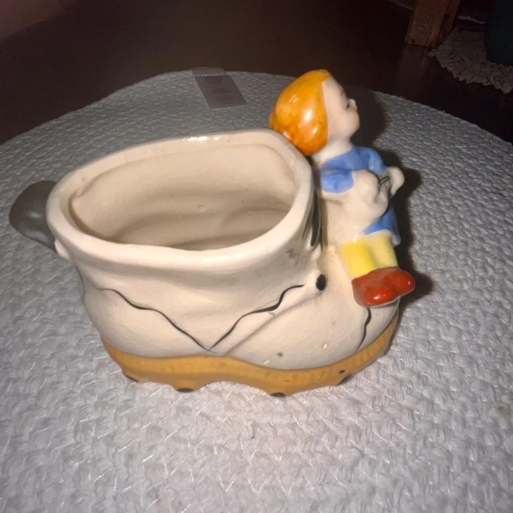 Vintage ceramic shoe with angel figurine planter